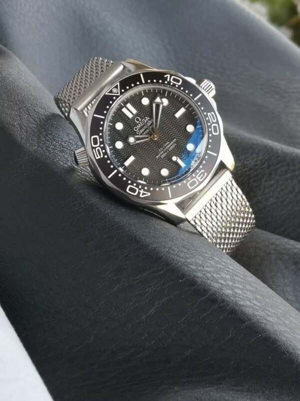 Replica Omega Seamaster No Time To Die Watch James Bond – Black Dial And Bezel The Replica Omega Seamaster No Time To Die Pays Tribute To The Iconic James Bond 007 Franchise. This Super Clone Seamaster Is Built With 904L Stainless Steel And Titanium Finishing, Mirroring The Exact Look And Feel Of The Original Watch Worn By Daniel Craig In No Time To Die. The Matte Black Dial And Matching Bezel Create A Bold, Stealth-Inspired Design Perfect For Collectors And Bond Enthusiasts. Equipped With A Swiss Automatic Clone Movement, This Seamaster Replica Delivers Smooth Second-Hand Sweep, Reliable Timekeeping, And Excellent Durability. The Sapphire Crystal Glass, Helium Escape Valve, And 42Mm Case Ensure Authenticity And Comfort, While The Nato Strap Or Stainless Steel Bracelet Gives Flexibility In Style. This Model Is A 1:1 Luxury Replica With All The Correct Engravings, Weight, And Finishing, Making It Indistinguishable From The Original Omega Seamaster 007 Edition. Specifications: Model: Omega Seamaster Diver 300M “No Time To Die” James Bond Edition Grade: Swiss Super Clone – 1:1 Case Material: 904L Stainless Steel With Titanium Finish Dial: Matte Black With Vintage Super-Luminova Markers Bezel: Black Ceramic Unidirectional Bezel Movement: Swiss Automatic Clone Of Omega 8806 Glass: Sapphire Crystal With Anti-Reflective Coating Bracelet/Strap: Stainless Steel Mesh Or Nato Strap Size: 42Mm Case Diameter Water Resistance: 5Atm